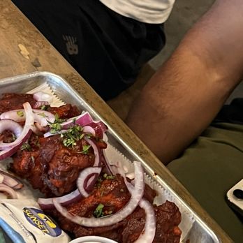 RAPPOURT - Tandoori wings, too spicy for the one who ordered and more of a wet wing then a crispy one - Bars Near Me - Ann Arbor, Michigan
