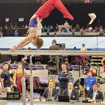 Mortgage Matchup Center - Parallel bar trick with a double pike in the air behind him. - Stadiums & Arenas Near Me - Phoenix, Arizona Mortgage Matchup Center - Parallel bar trick with a double pike in the air behind him. - Stadiums & Arenas Near Me - Phoenix, Arizona