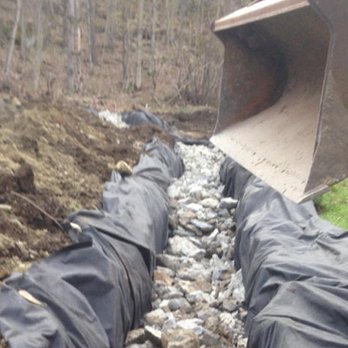 All Phase Property Maintenance - a large excavator digging a trench - Landscaping Near Me - Essex Junction, Vermont All Phase Property Maintenance - a large excavator digging a trench - Landscaping Near Me - Essex Junction, Vermont