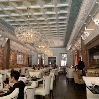 Hamptons - a dining room with white chairs and chandeliers - Wine Bars Near Me - Sumter, South Carolina Hamptons - a dining room with white chairs and chandeliers - Wine Bars Near Me - Sumter, South Carolina