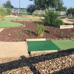 Kansas Sports Center - The mini golf course is full and weeds and most of the holes have severe wear and tear on the greens.
