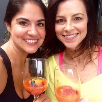Mercat Bistro - Specialty summer cocktail. Fruit ice ball topped with prosecco. - French Near Me - Dallas, Texas