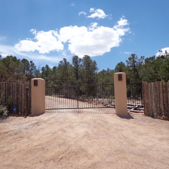 Valley Fence - a dirt road leading to a gate - General Contractors Near Me - Albuquerque, New Mexico
