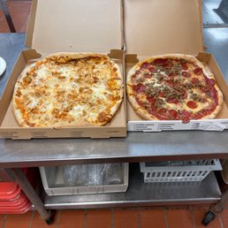 Buffalo chicken pizza and a sausage and pepperoni pizza