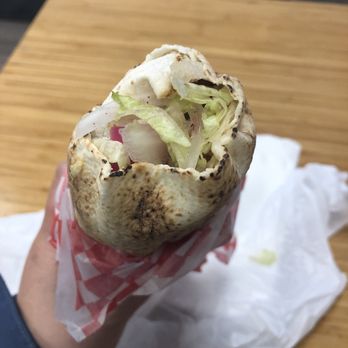 The Chick Pea Mediterranean Cuisine - a hand holding a burrito - Mediterranean Near Me - Calgary, Alberta The Chick Pea Mediterranean Cuisine - a hand holding a burrito - Mediterranean Near Me - Calgary, Alberta