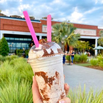 Bake'n Babes - a hand holding a chocolate milkshake - Desserts Near Me - Tampa, Florida