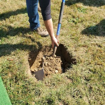 New Calvary Catholic Cemetery - Filling thr grave after casket has been placed. - Funeral Services & Cemeteries Near Me - Flint, Michigan