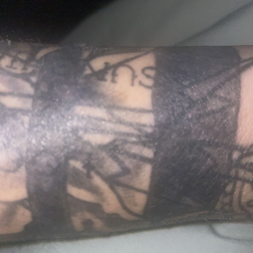 The Company - Close-up of blackwork band showing uneven edges and inconsistent saturation - Tattoo Near Me - Reno, Nevada