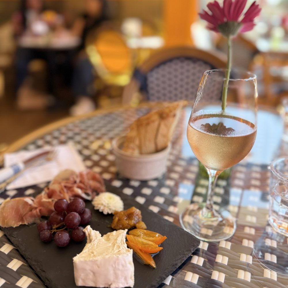 Small cheese and charcuterie plate and a glass of rosé Small cheese and charcuterie plate and a glass of rosé