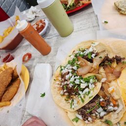 Tacos piled around the plate. It's like Taco heaven! The red sauce is delicious and spicy.