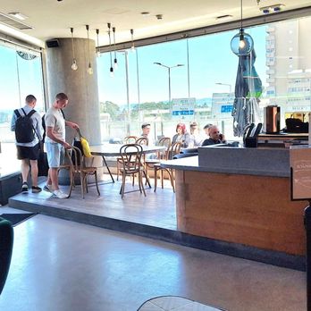 Starbucks - That is the bigger table out by the windows and part of the service counter at the right. - Cafes Near Me - Vila Nova de Gaia, 13