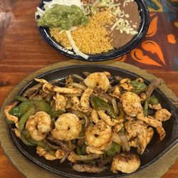 Jalisco Fajitas Chicken, steak, and shrimp. Fajitas grilled with bell peppers, onions.