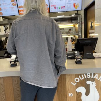 Popeyes Louisiana Kitchen - a woman standing at a counter - Fast Food Near Me - Shawnee, Oklahoma