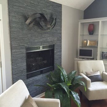 Pride Tile - a living room with two chairs and a fireplace - Flooring Near Me - Louisville, Kentucky