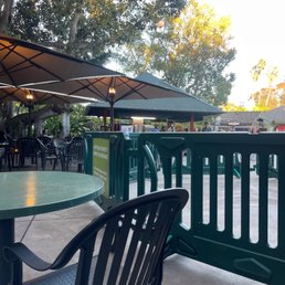 a patio with tables and umbrellas a patio with tables and umbrellas