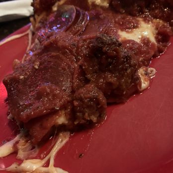 Pequod's Pizza - Close up side view of a slice of Medium Pan Pizza ($22.45) with pepperoni ($3.95) and sausage ($3.95) - Pizza Near Me - Chicago, Illinois Pequod's Pizza - Close up side view of a slice of Medium Pan Pizza ($22.45) with pepperoni ($3.95) and sausage ($3.95) - Pizza Near Me - Chicago, Illinois
