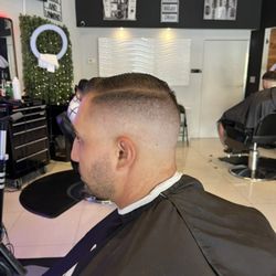 The Modern Gentlemen’s Barbershop - Clean fade with side part .