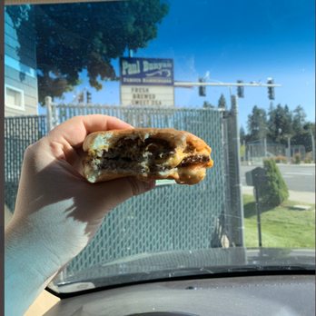 Paul Bunyan Pak-Out - a hand holding a half eaten sandwich - Burgers Near Me - Coeur D Alene, Idaho