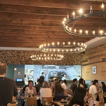 Doppio Zero Mountain View - Interior view of wood ceiling / river rock studded wall / open kitchen view. - Pizza Near Me - Mountain View, California Doppio Zero Mountain View - Interior view of wood ceiling / river rock studded wall / open kitchen view. - Pizza Near Me - Mountain View, California