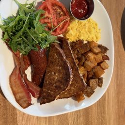 Breakfast platter with eggs, bacon, sausage, potatoes, tomato and toast Breakfast platter with eggs, bacon, sausage, potatoes, tomato and toast