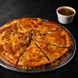 Fuego Cravings - Our famous Birria Pizza loaded with crispy cheese crust, slow-cooked birria & melted cheese served with rich consommé for dipping