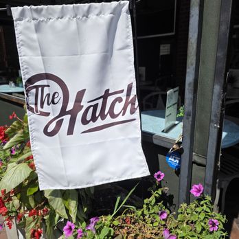 The Hatch - A sign outside the entrance with colorful flowers. - Southern Near Me - Roanoke, Virginia The Hatch - A sign outside the entrance with colorful flowers. - Southern Near Me - Roanoke, Virginia