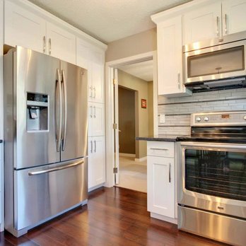 Marble & Granite Renovations - a kitchen with stainless steel appliances - Kitchen & Bath Near Me - Calgary, Alberta Marble & Granite Renovations - a kitchen with stainless steel appliances - Kitchen & Bath Near Me - Calgary, Alberta