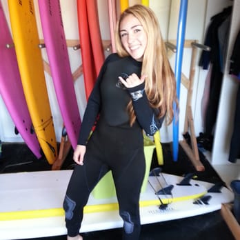 Newport Beach Surfing Lessons - Taylor getting all suited up. - Surf Schools Near Me - Newport Beach, California Newport Beach Surfing Lessons - Taylor getting all suited up. - Surf Schools Near Me - Newport Beach, California