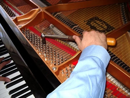 I tune by ear as I learned from a Piano Master Technician. - Irrespective of modern technology, a piano can't be perfectly tuned using an electronic tuning instrument. The reason is seldom known among even piano tuners.  Professional classical pianists insist on their performance pianos having their instruments tuning Stretched.  That's because a piano's notes are not a half step apart, but slightly more.  So to be properly in tune, the notes must be tuned to the harmonics of the previous octave's harmonic.   And the electronic instruments only know the common octave settings.