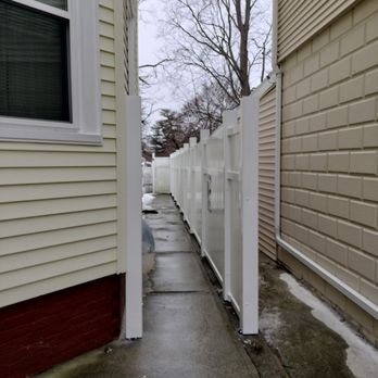 Joshua Services - Installation of vinyl fence on concrete wall using concrete anchors and bolts - Landscaping Near Me
