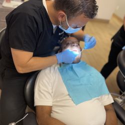 Dr. Kerio working on dental implants on patient