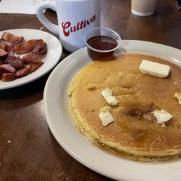 One Cake with side of bacon and sausage. Coffee One Cake with side of bacon and sausage. Coffee