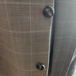 Olympic Tailor Shop - One button was moved and the other was not.