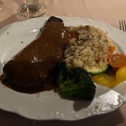 Golf's Steak House - Peppercorn New York strip loin steak with rice pilaf.