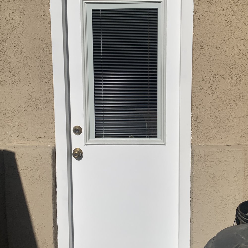 a white door with blinds a white door with blinds