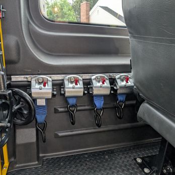 RideToo - Four retractors for every mobility device, always. Seen here, hung neatly, ready for our next ride: Easy for drivers, clean for safety. - Medical Transportation Near Me - Greenwood Village, Colorado RideToo - Four retractors for every mobility device, always. Seen here, hung neatly, ready for our next ride: Easy for drivers, clean for safety. - Medical Transportation Near Me - Greenwood Village, Colorado