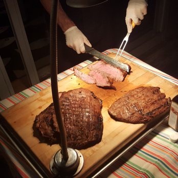 Okie's Butcher Shop - a person cutting meat on a cutting board - Delis Near Me - Surf City, New Jersey Okie's Butcher Shop - a person cutting meat on a cutting board - Delis Near Me - Surf City, New Jersey