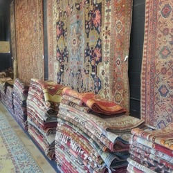 Farzin Rugs - Stack of hundreds of rugs!  Beautiful. Mesmerizing.