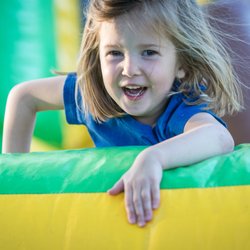 Parish Summer - Girl has fun on an inflatable obstacle course. Parish Summer's Day Camp brings in inflatables and water slides to enhance the summer fun.
