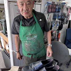 Paco's Shoe Repair - Paco with the shoes looking rough