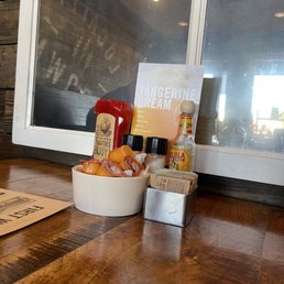 a bowl of hot sauces and condiments on a table