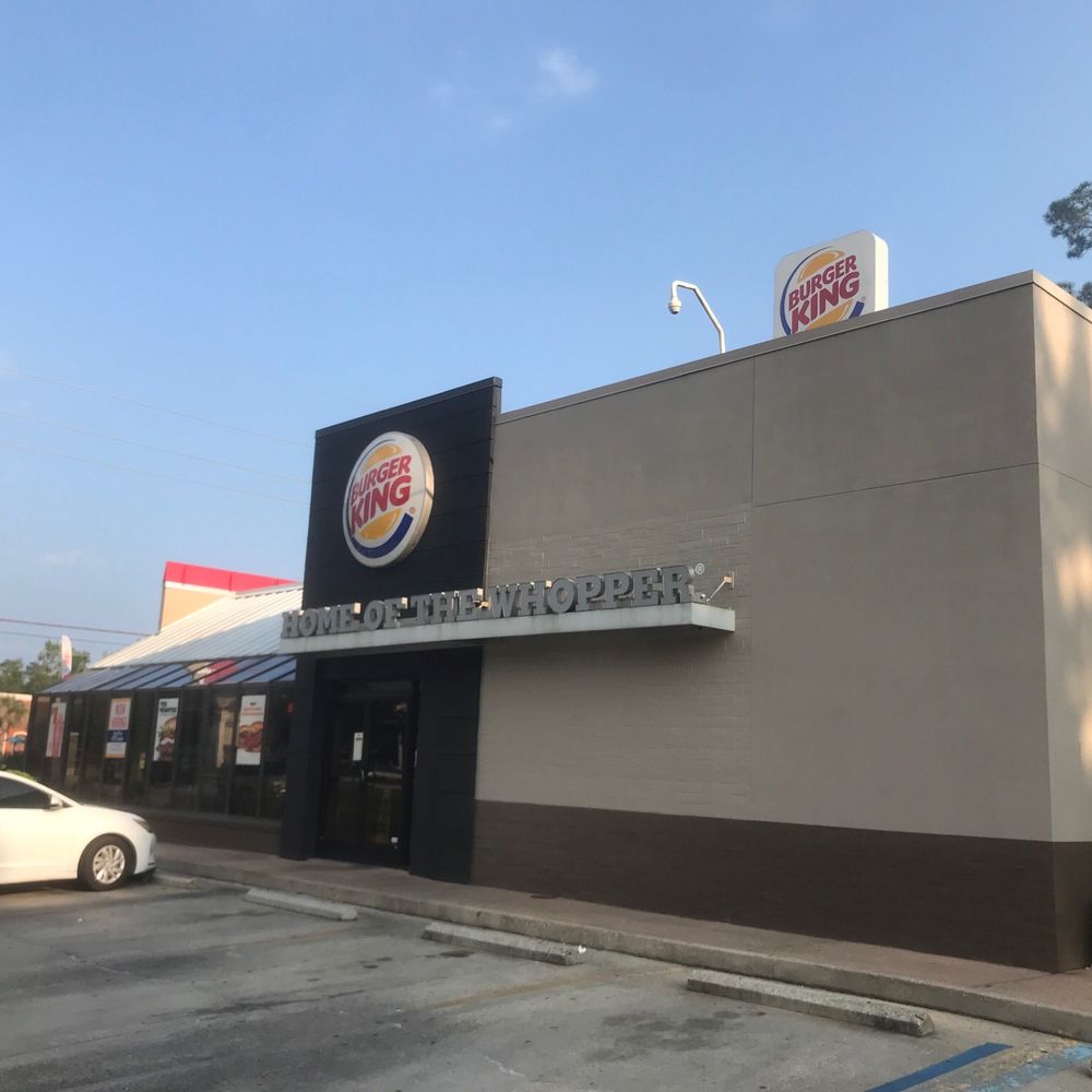 a white car parked in front of the restaurant
