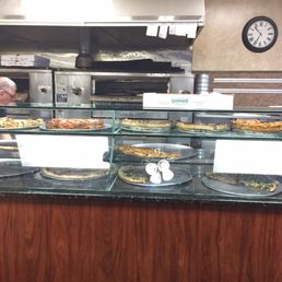 a counter with a variety of pies