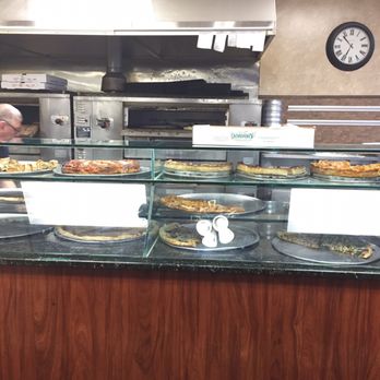 Amore Pizza - a counter with a variety of pies - Pizza Near Me - Bay Shore, New York