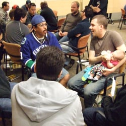 Boot Camp For New Dads - Rookie Dads listen as a Vet and his baby answer their questions during the small-group break out part of the workshop.