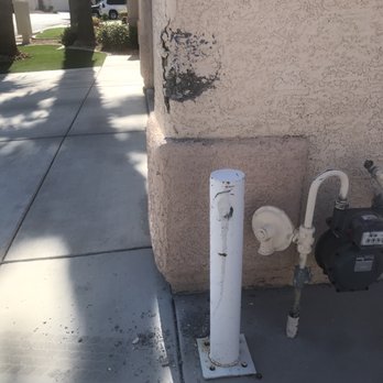 Leo Restoration and Construction - Damaged house wall and gas meter barrier. - General Contractors Near Me