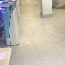 Four Seasons Nails & Spa - The floor that has trash on it