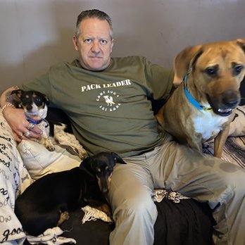 Camp Zoo & Pet Ranch - Mark, the pack leader, loving on 3 dogs. - Pet Boarding Near Me - Austin, Texas Camp Zoo & Pet Ranch - Mark, the pack leader, loving on 3 dogs. - Pet Boarding Near Me - Austin, Texas