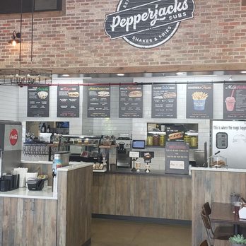 Pepperjacks Subs - a man sitting at a table - Sandwiches Near Me - Annapolis Junction, Maryland