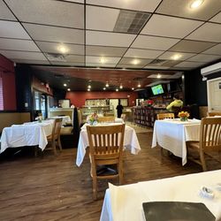 Luanda Restaurant & Event Space - Staff member shouting to person across the empty restaurant while we're dining .